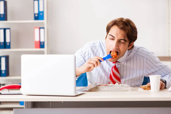 Man having meal at work during break