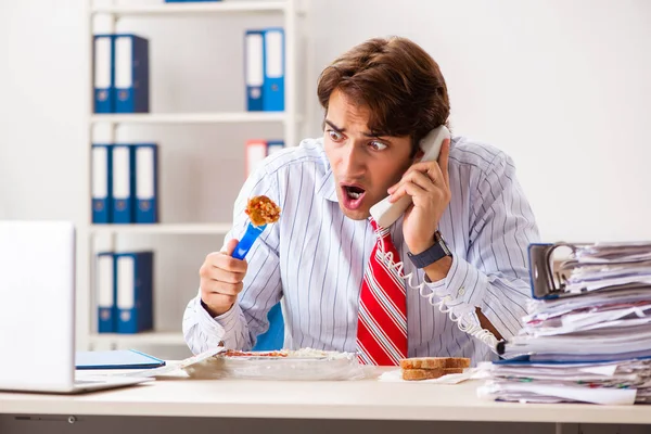 Man having meal at work during break