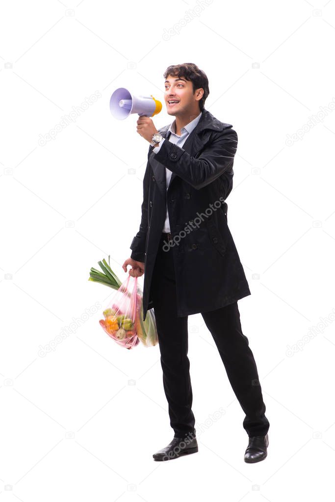 Young handsome man with vegatables in shopping concept 