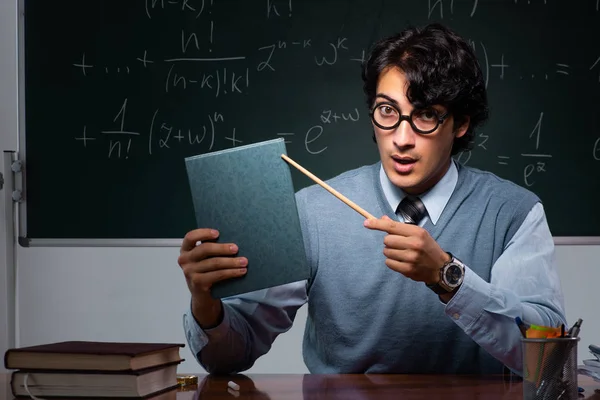 Young math teacher in front of chalkboard — Stock Photo, Image