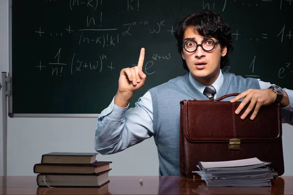 Young math teacher in front of chalkboard — Stock Photo, Image
