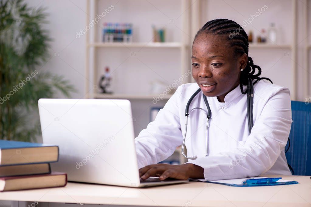 Black female doctor working at clinic 