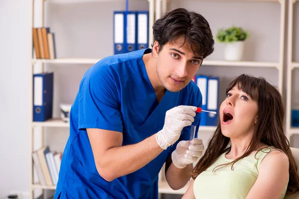 Doctor getting saliva test sample in clinic hospital