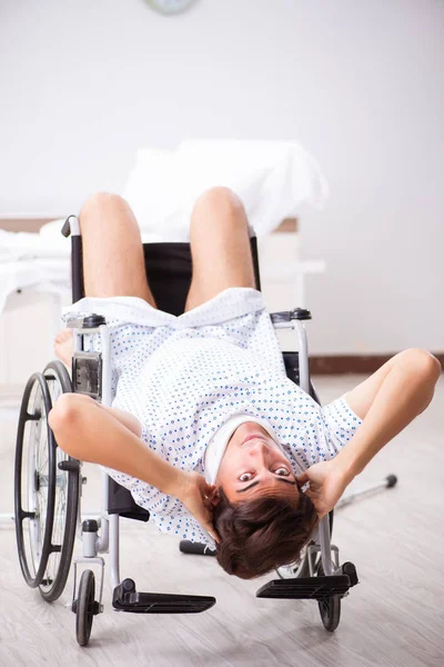 Young handsome man in wheelchair at the hospital — Stock Photo, Image