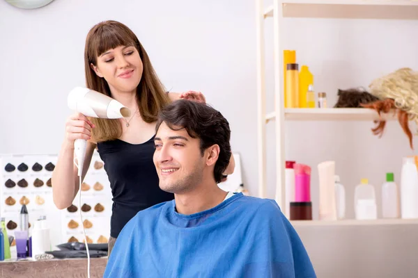 Jovens atraem homem visitando barbeiro feminino — Fotografia de Stock