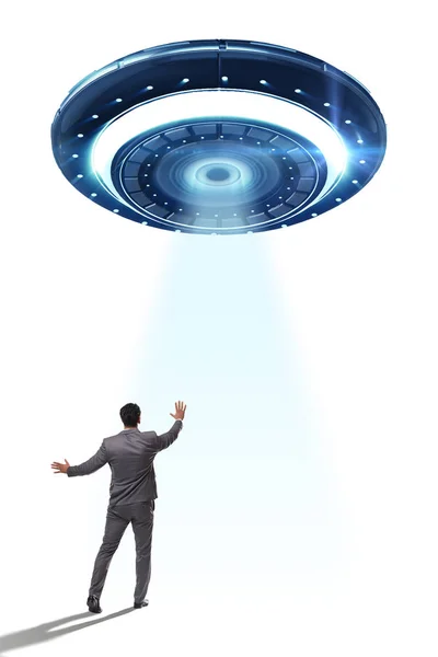 Flying saucer abducting young businessman — Stock Photo, Image