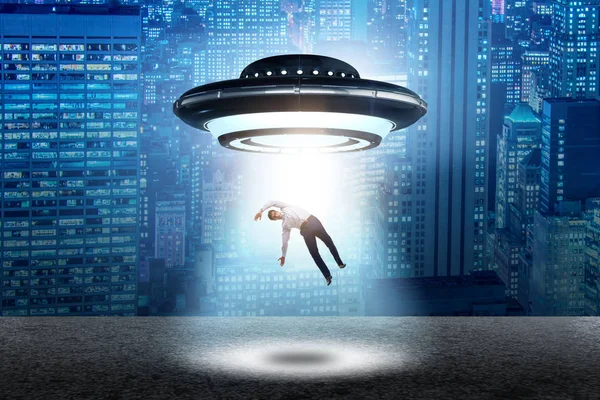 Flying saucer abducting young businessman