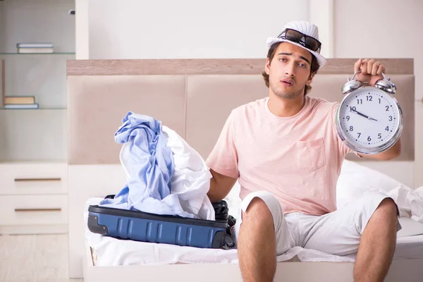 Man with suitcase in bedroom waiting for trip — Stock Photo, Image