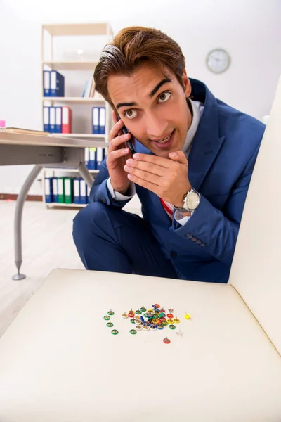 Office prank with sharp thumbtacks on chair