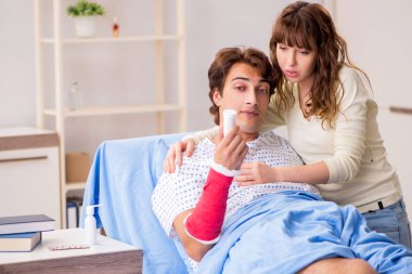 Hastanede yaralı kocayla ilgilenen sevgili bir eş. 