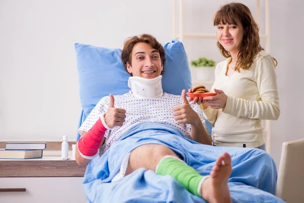 Loving wife looking after injured husband in hospital