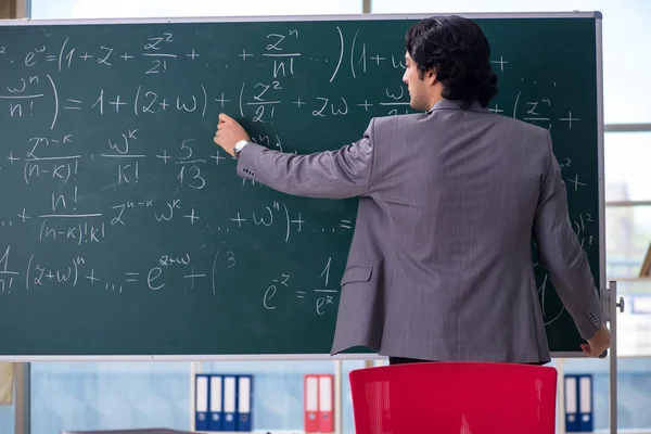 Young handsome math teacher in classroom — Stock Photo, Image