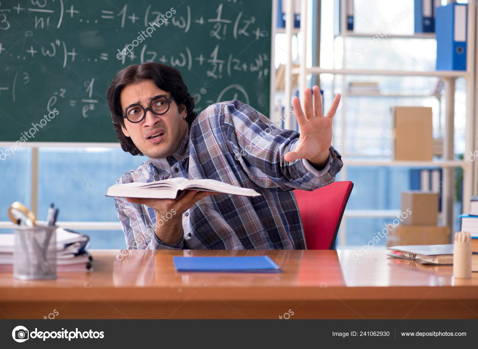 Young funny math teacher in front of chalkboard Stock Photo by ...