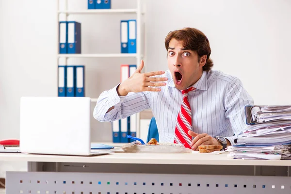 Man having meal at work during break