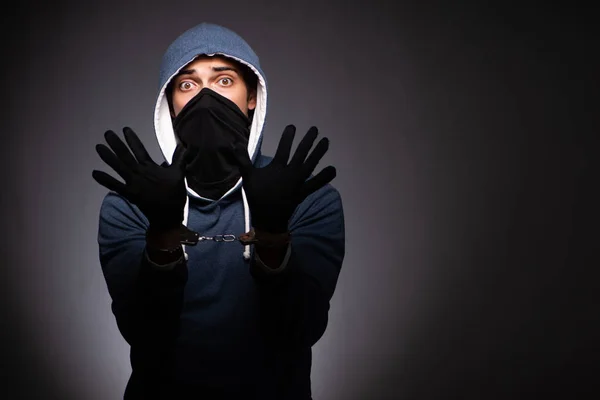 Young gangster in hood on grey background — Stock Photo, Image