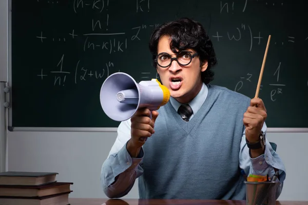 Young math teacher in front of chalkboard