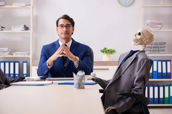 Funny business meeting with boss and skeletons