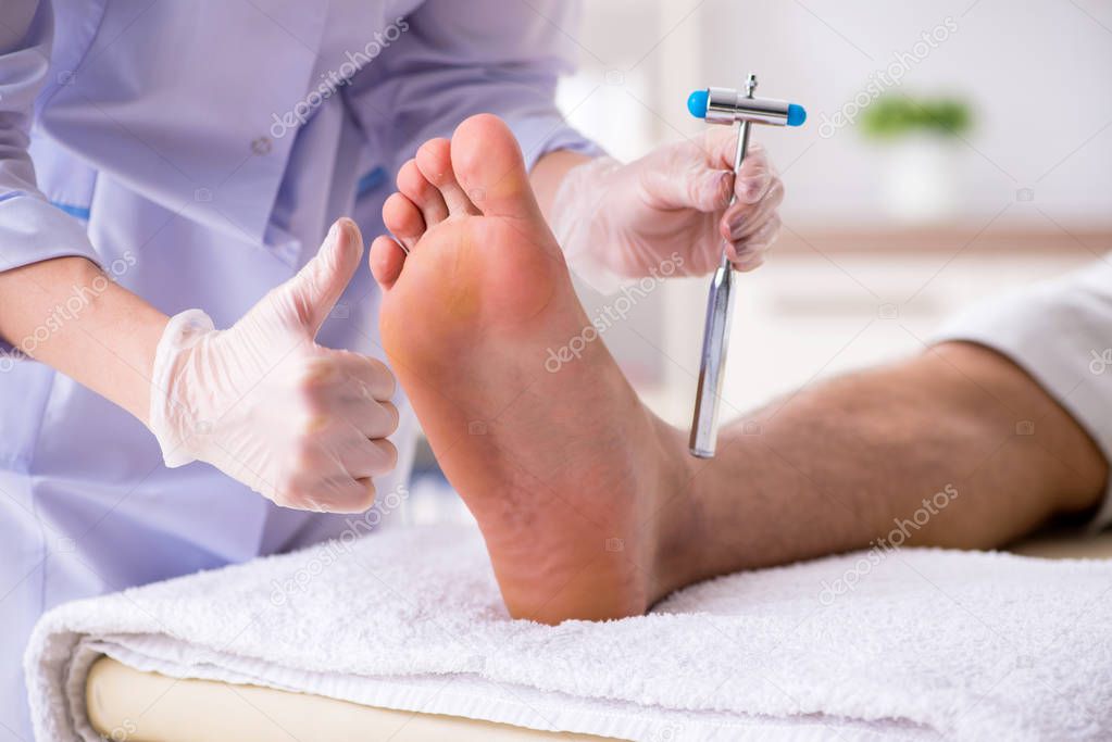 Podiatrist treating feet during procedure
