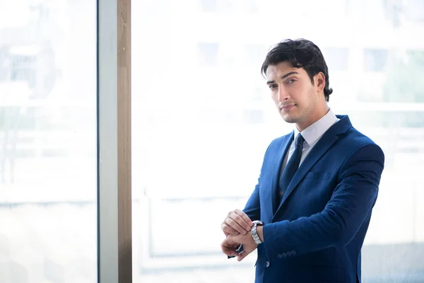 Young handsome businessman standing at the window — Stock Photo, Image