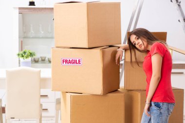 Young beautiful woman moving to new flat  clipart
