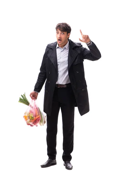 Joven hombre guapo con verduras en concepto de compras —  Fotos de Stock