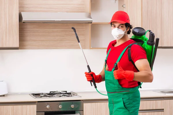 Professional contractor doing pest control at kitchen — Stock Photo, Image