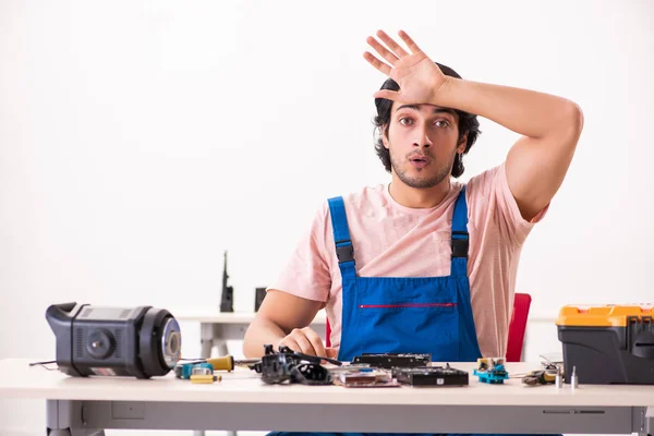 Young male contractor repairing computer — Stock Photo, Image