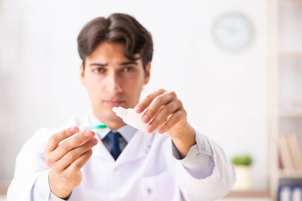 Young handsome doctor oculist working at the clinic — Stock Photo, Image