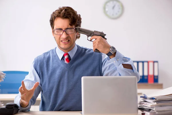 Young handsome employee unhappy with excessive work — Stock Photo, Image