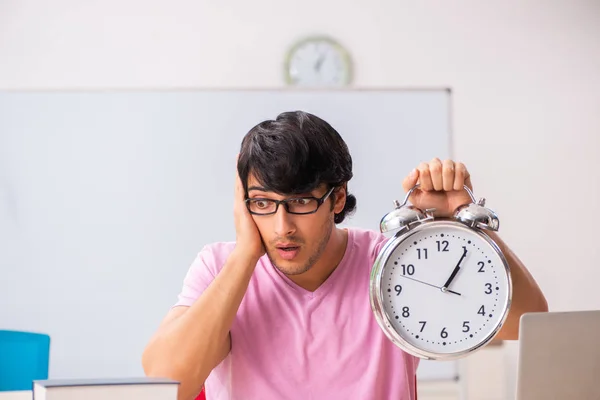 Young male student sitting in the class — Stock Photo, Image