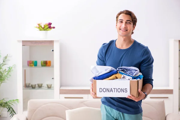 Concept of charity with donated clothing — Stock Photo, Image