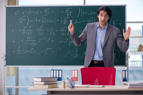 Young handsome math teacher in classroom — Stock Photo, Image