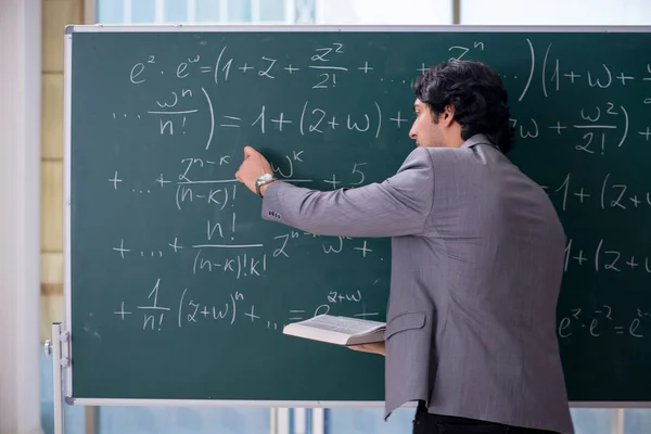 Young handsome math teacher in classroom — Stock Photo, Image