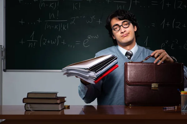 Young math teacher in front of chalkboard — Stock Photo, Image