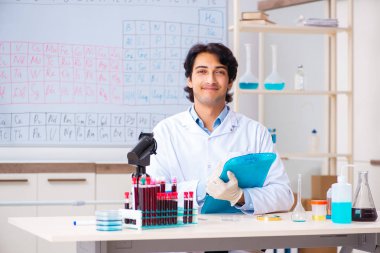 Laboratuvarda çalışan genç bir kimyager.