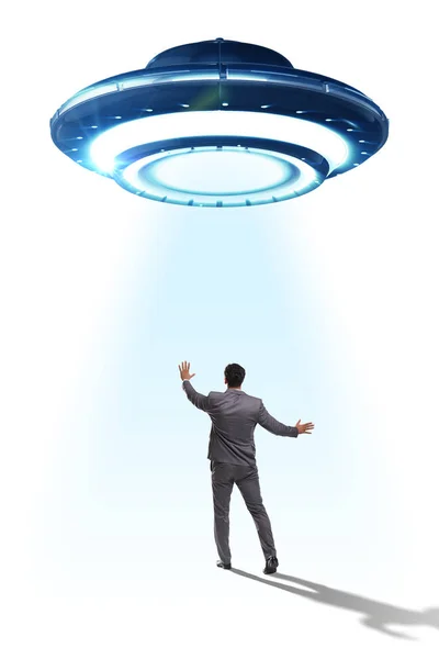 Flying saucer abducting young businessman — Stock Photo, Image