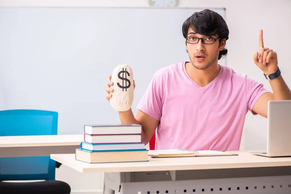 Giovane studente maschio seduto in classe — Foto Stock