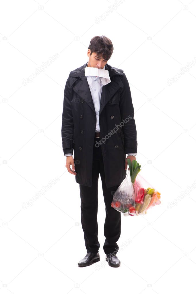 Young handsome man with vegatables in shopping concept
