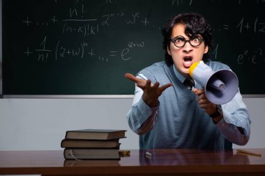 Kara tahta önünde genç matematik öğretmeni