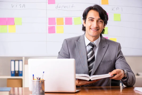 Young handsome employee working in the office — Stock Photo, Image