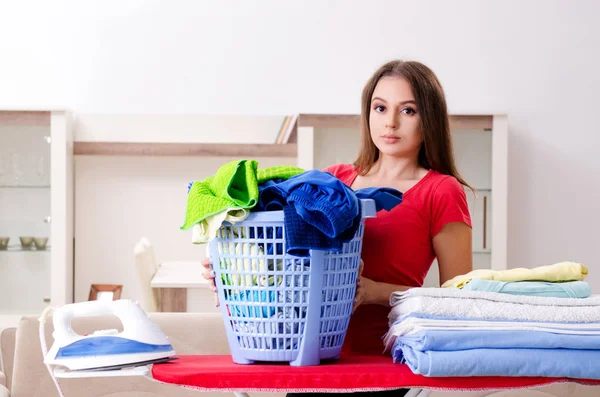 Young beautiful woman ironing at home — Stock Photo, Image