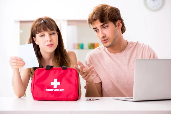 Young family getting treatment with first aid kit