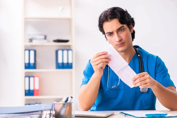 Young handsome doctor working at the clinic — Stock Photo, Image