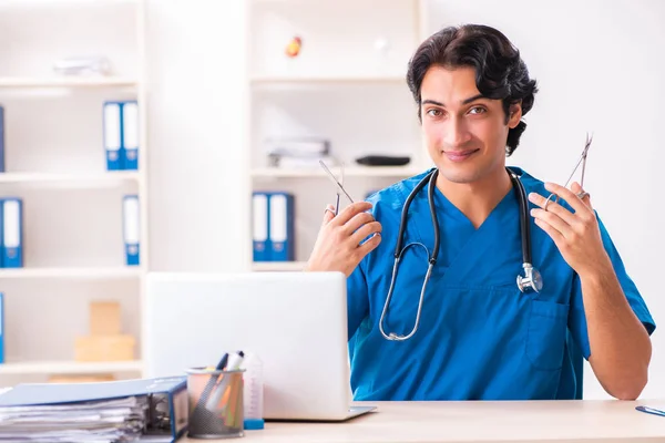 Young handsome doctor working at the clinic — Stock Photo, Image