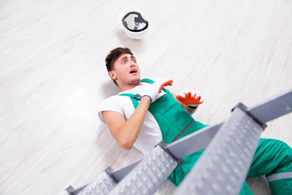 Young worker falling from the ladder — Stock Photo, Image