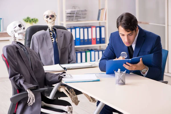 Funny business meeting with boss and skeletons — Stock Photo, Image