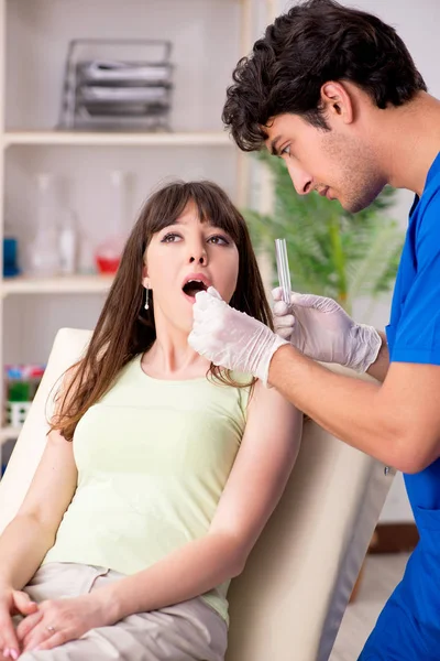 Doctor getting saliva test sample in clinic hospital