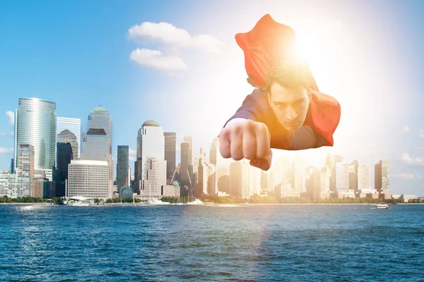 Superhero businessman flying over the city — Stock Photo, Image