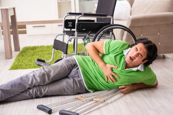 Young handsome man in wheelchair at home — Stock Photo, Image