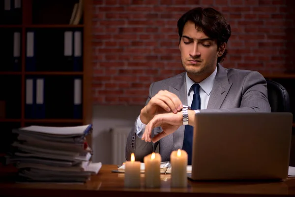 Businessman working late in office with candle light — Stock Photo, Image